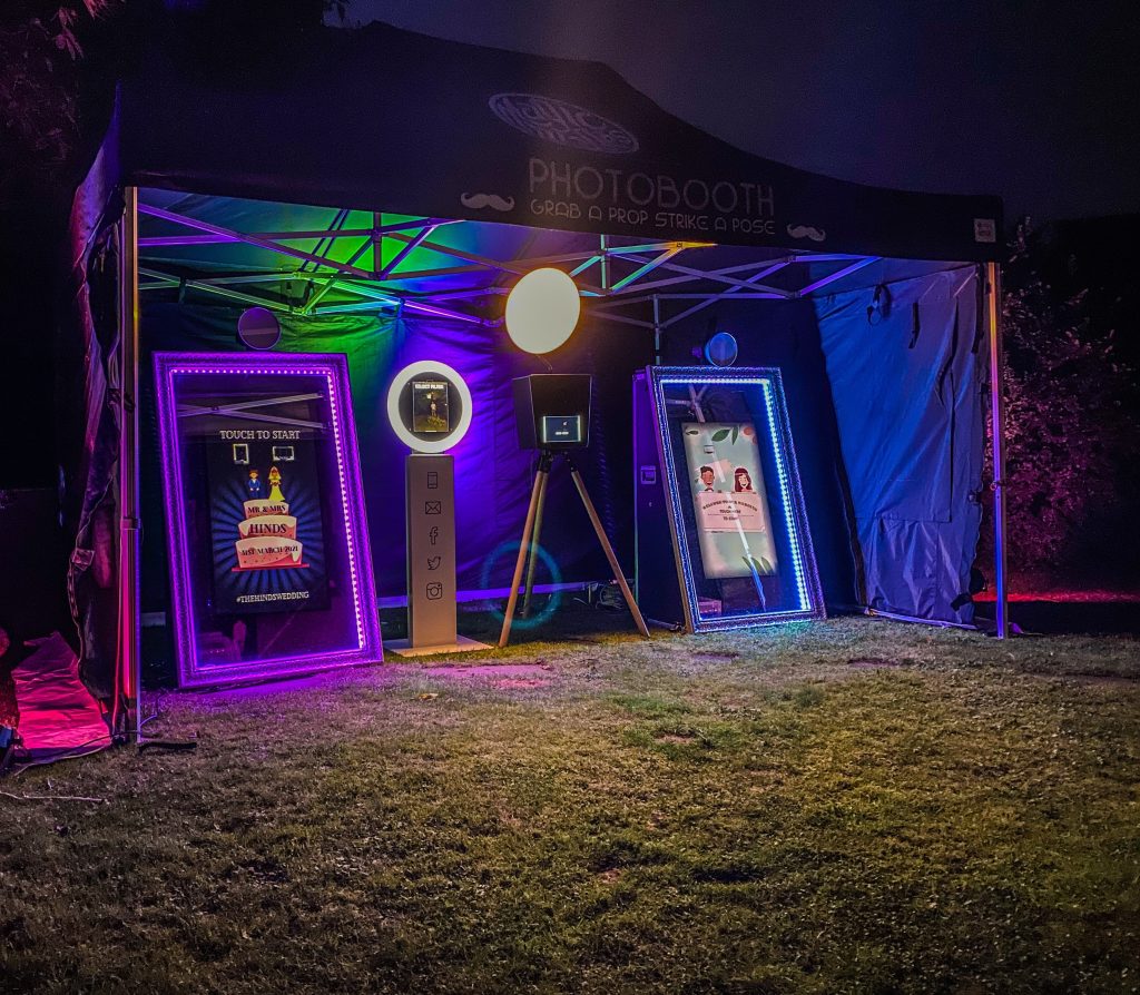 four photo booths positioned within an event marquee
